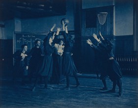 Female students playing basketball in a gymnasium, Western High School, Washington, D.C., (1899?).