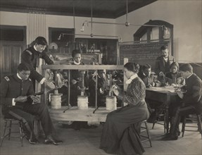 The cheese press screw - students studying agricultural sciences, Hampton Institute, Hampton, Virginia, 1899 or 1900.