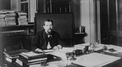 Mr. McClelland(?), Treasury Department employee, half-length portrait, seated at desk, facing front, between 1884 and 1930.