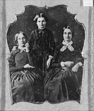 Three unidentified women, two seated, one standing, facing front, between 1840 and 1860. Creator: Unknown.