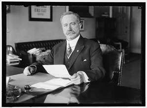 John Skelton Williams at Desk, between 1913 and 1918. Creator: Harris & Ewing.
