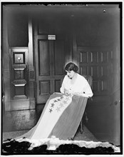 Sewing stars on suffrage flag, between 1910 and 1920. Creator: Harris & Ewing.