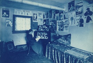 Frances Benjamin Johnston seated at a desk in her studio/office, with adverstising..., c1896. Creator: Frances Benjamin Johnston.
