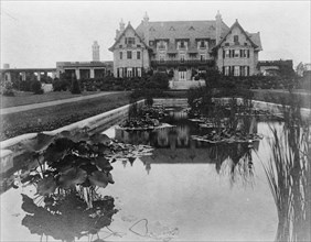 Facade of home of Edmund Cogswell Converse, with lily pond in..., Greenwich, Connecticut, 1908. Creator: Frances Benjamin Johnston.