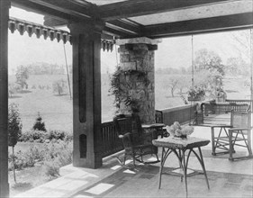 Porch with wicker furniture, and view over lawn to home of Edmund..., Greenwich, Connecticut, 1908. Creator: Frances Benjamin Johnston.