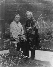 Frances B. Johnston in garden in New Orleans with "Pops" Whitesell, who is holding..., c1945 - 1952. Creator: Frances Benjamin Johnston.