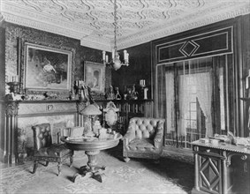 Room with plasterwork ceiling, fireplace, and circular table.., Greenwich, Connecticut, 1908. Creator: Frances Benjamin Johnston.
