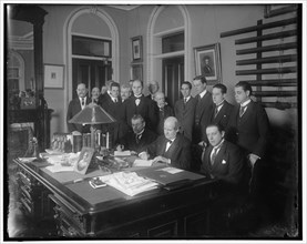 William Jennings Bryan with group at desk, between 1910 and 1920. Creator: Harris & Ewing.