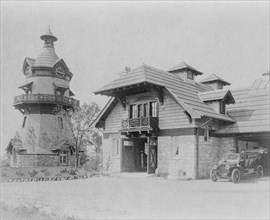 Windmill-shaped clock tower at left, and part of garage of Edmund..., Greenwich, Connecticut, 1908. Creator: Frances Benjamin Johnston.