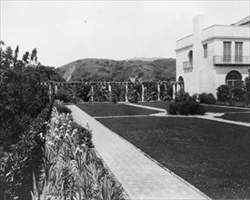 Pasadena, California, Mrs. Herbert Coppell home - view of formal lawn, gardens, and hills..., 1917. Creator: Frances Benjamin Johnston.