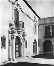 Pasadena, California, Mrs. Herbert Coppell home - detail of ornate doorway and balcony above, 1917. Creator: Frances Benjamin Johnston.