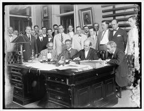 Group: includes William Jennings Bryan (at desk, 2nd from right)..., between 1910 and 1920. Creator: Harris & Ewing.
