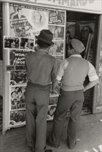 Mexican boys looking at movie poster, San Antonio, Texas,  1939-03.