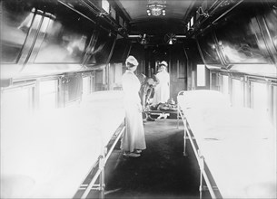 Army, U.S, Hospital Car - Interior, 1917. Soldier is stretchered on board.
