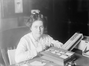 Mrs. J.C. Crawford of Smithsonian, 1914. Woman with pinned butterfly specimens.