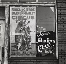 Barber shop window [with circus poster] in Birmingham, Alabama,  1937-01 - 1937-02.