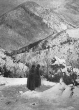 'Dans le sentier de l'exil; Soutenu par son aide de camp, le roi Pierre de Serbie traverse..., 1916. Creator: R. Marianovitch.