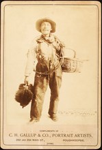 John King, chimney sweep, shown with gear while singing out his call, ca. 1880 - 1889.