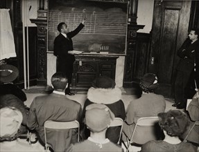 Music class with instructor at the board, 1935 - 1943.