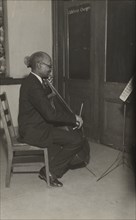 A cello student of the Adult Education Classes under the Federal Music Project at Carlton YMCA, 1936.