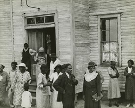 Sunday in Little Rock, Ark., 1935. African Americans standing and socializing in front of a house.