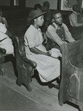 African Americans sitting in pews at a meeting of Farm Security Administration borrowers..., 1941. Creators: Farm Security Administration, Jack Delano.