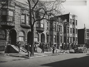 Old brown stonehouses now occupied by Negroes in Chicago, Illinois, April 1941.