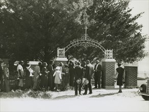 On All Saints' Day at New Roads, La. African Americans lined up at gates to enter cemetry, 1938.