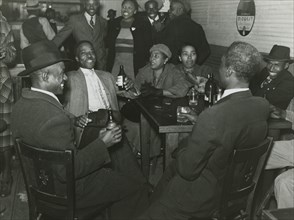 African Americans conversing and drinking beers in a bar, Clarksdale, Mississippi Delta, November 1939.