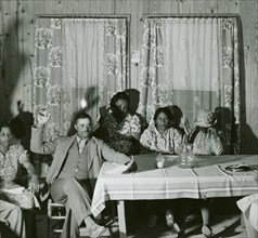 African American men and women sitting in attendance at a meeting to discuss farm..., May 1940. Creator: Farm Security Administration.