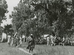 African Americans walking in an open field at a picnic, Beaufort, South Carolina, July 4, 1939.