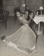 Zola King, eccentric dancer doing her nightly stunt in the cabaret scene, 1937.
