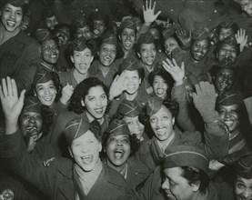 A crowd of African American Women's Army Corps members waving at the camera..., 1946. Creator: Unknown.