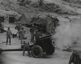 Vietnamese artillerymen fire from a mountain position during field training, 1962.