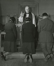 An Episcopal Bishop confirming African American Lieutenants Rosemary Vincent..., 1939 - 1945. Creator: United States Army.
