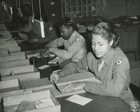 Members of the Women's Army Corps identifying incorrectly addressed mail for soldiers..., 1943. Creator: Unknown.