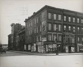 Boarded residential building on the corner of Madison Avenue and East 133rd Street, Harlem, New York City, 1938.
