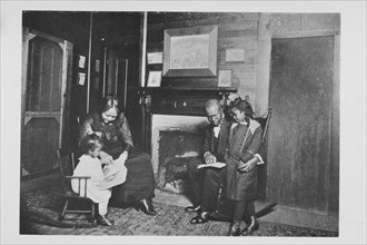 An African American family; Reading books, 1922. Creator: Unknown.
