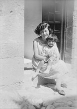 Cenerini, Mrs., and child, seated on a doorstep, 1929 Creator: Arnold Genthe.