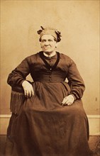 Portrait of seated woman wearing a headwrap, c1870. Creator: Thomas M Saurman.
