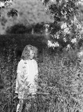 Dunning, Mr., daughter of, standing in a garden, 1925 July 9. Creator: Arnold Genthe.