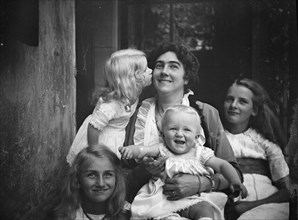 Unidentified woman with four children, portrait photograph, between 1911 and 1942. Creator: Arnold Genthe.