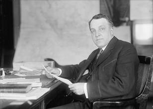 William Moulton Ingraham, Asst. Secretary of War, at Desk, 1916. Creator: Harris & Ewing.