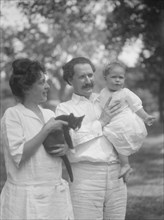 Nadelman, Mr. and Mrs., with baby and cat, standing outdoors, 1923 July 12. Creator: Arnold Genthe.