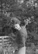 Le Gallienne, Eva, with cat, outdoors, 1937 Creator: Arnold Genthe.