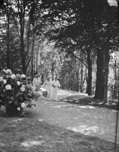 Leslie, Margeurite, and unidentified couple, walking in the woods, 1917 Aug. 18. Creator: Arnold Genthe.