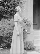 Alanson, Bertram, Mrs., standing outdoors, between 1927 and 1937. Creator: Arnold Genthe.