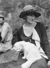 Egger, Gabrielle, Miss, with cat, seated outdoors, between 1926 and 1930. Creator: Arnold Genthe.