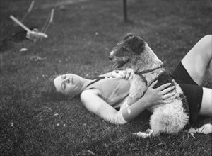 McKeogh, Arthur, Mrs., with dog, outdoors, 1927 Creator: Arnold Genthe.