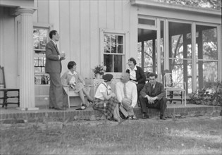 Rothbart, Albert, Mr., group, seated on a porch, between 1920 and 1935. Creator: Arnold Genthe.